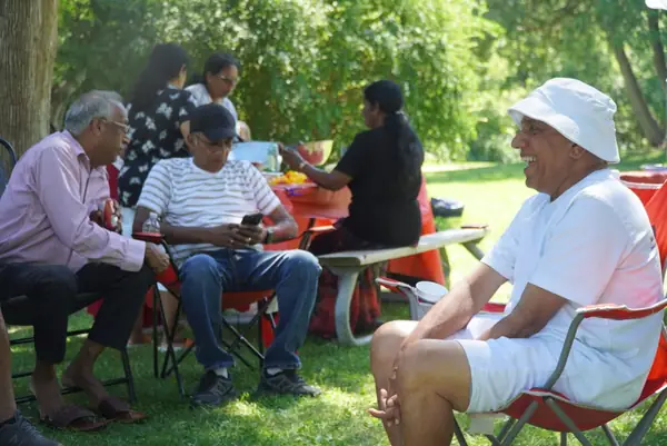 People chatting in lawn chairs in a park