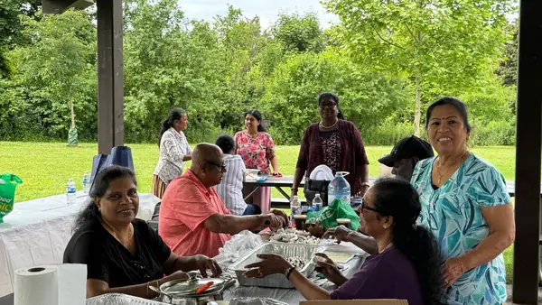 People seated together at a picnic table
