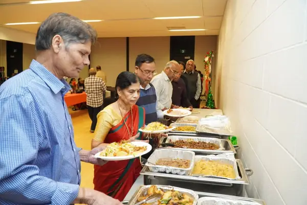 People serving themselves from a buffet indoors