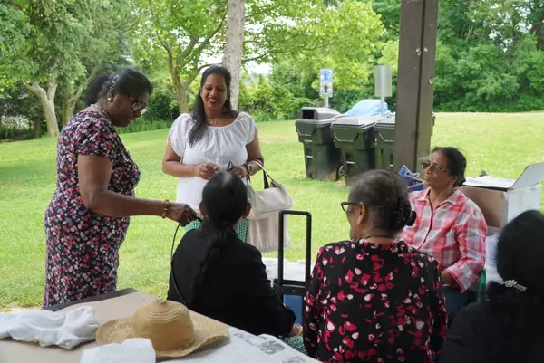 People chatting at a picnic table