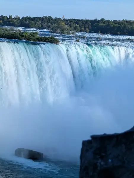 Close view of a waterfall with rising mist