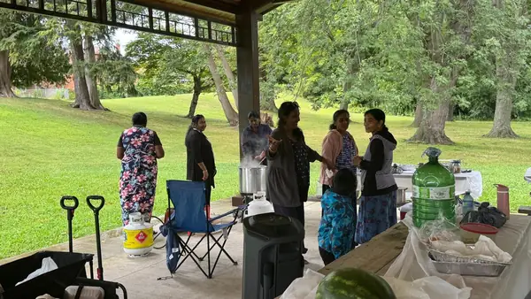 People gathered under a park pavilion