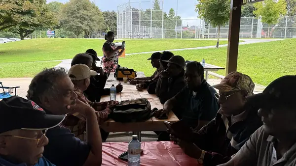 People seated at tables outdoors