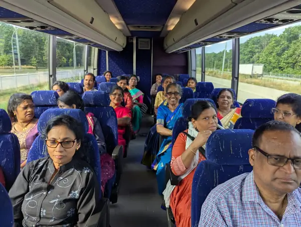 People seated on a tour bus