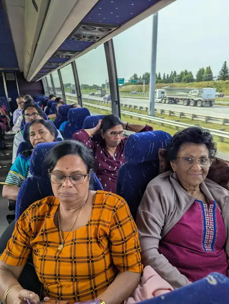 People smiling on a tour bus