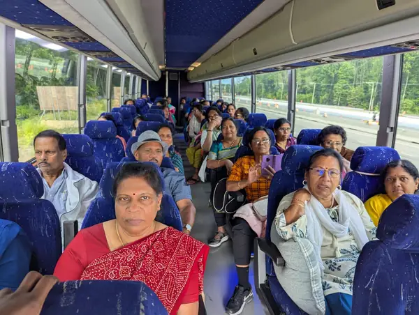 People seated on a tour bus