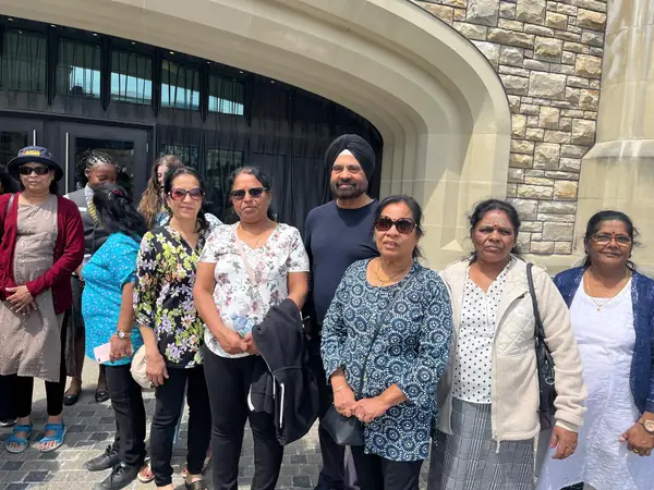 Group posing in front of a stone archway