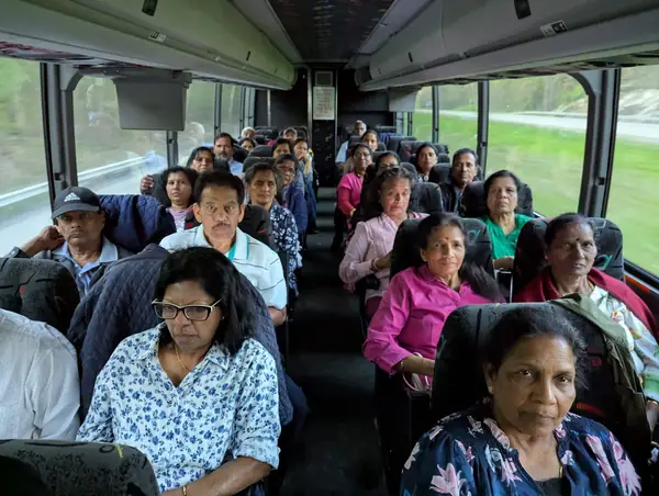 People seated on a tour bus