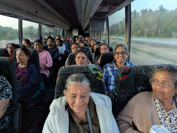 People seated on a tour bus