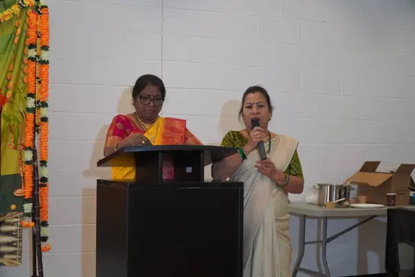 Two women speaking at a podium