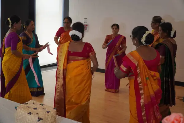 Women in saris dancing indoors