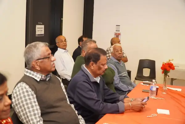 People talking at a table in a hall