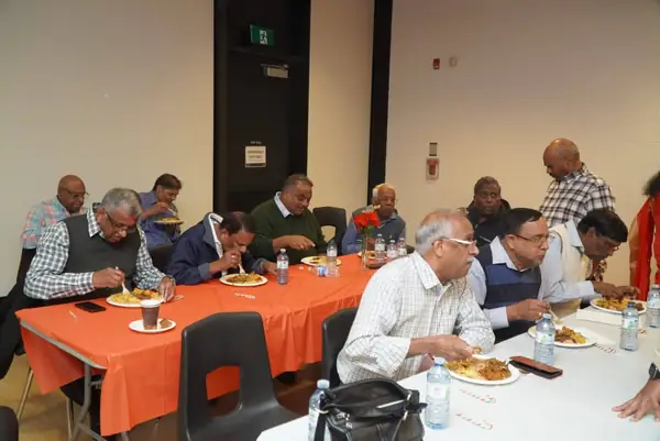 People seated at tables in a hall