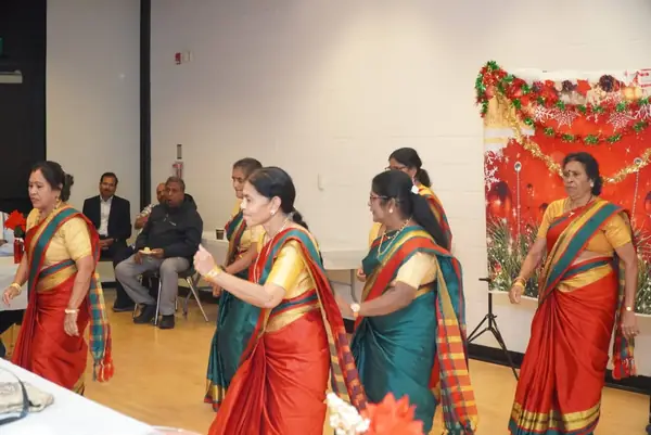 Women in saris dancing in a hall