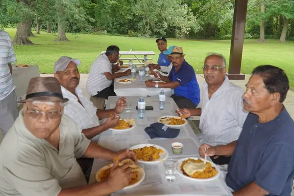 People sharing a meal at a picnic table