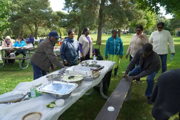 People seated at a long picnic table