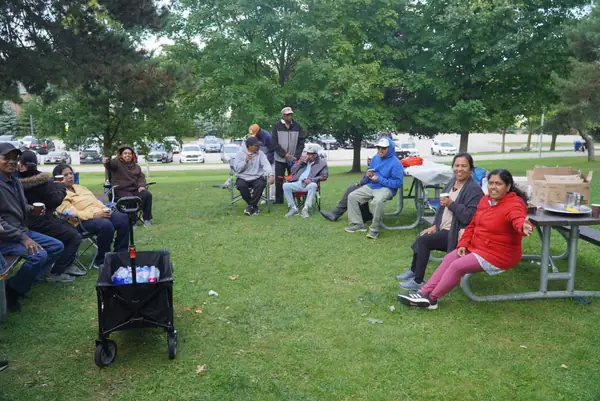 People relaxing on a lawn in a park
