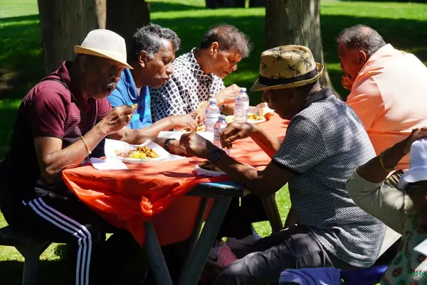 People sharing a meal at a picnic table