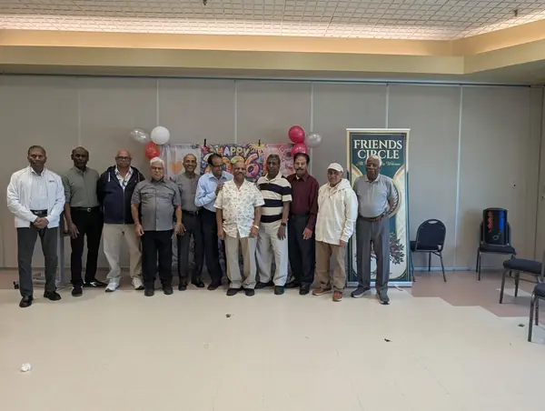 Group of men posing in a hall