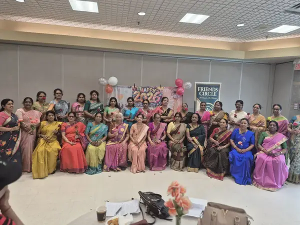 Large group seated and standing in a hall