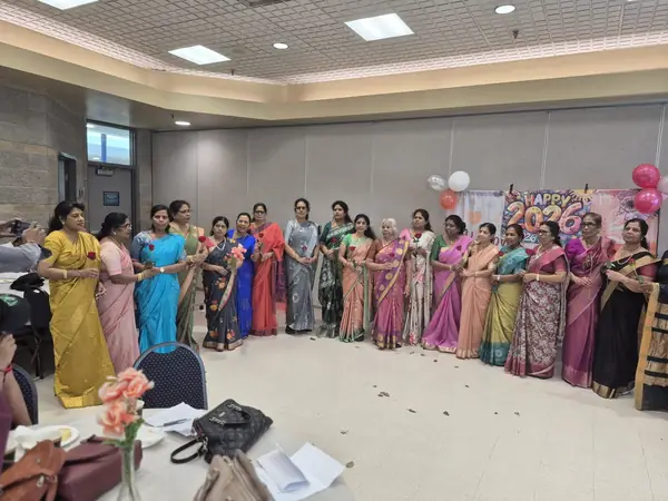 Row of women in saris in a hall