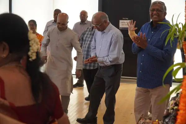 People dancing and clapping in a hall