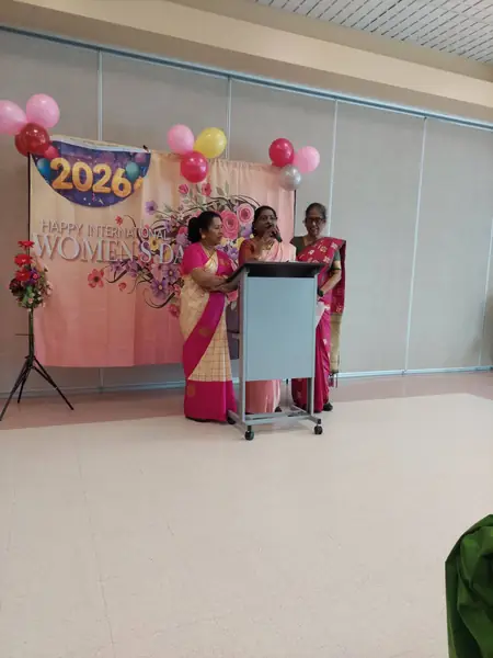 A woman speaking at a podium beside a 2026 backdrop