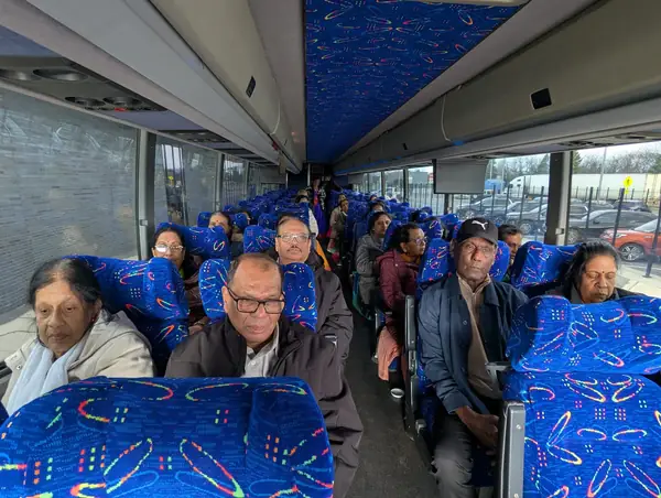 People seated on a tour bus