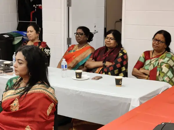 Women seated at tables in a hall