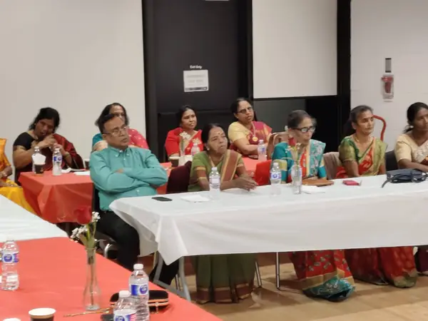 People seated at tables in a hall